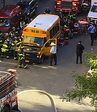 After crashing the truck into a school bus, the suspect exited the vehicle while displaying imitation firearms and was shot in the abdomen by a police officer, according to the NYPD./ Source:	Paul Moses