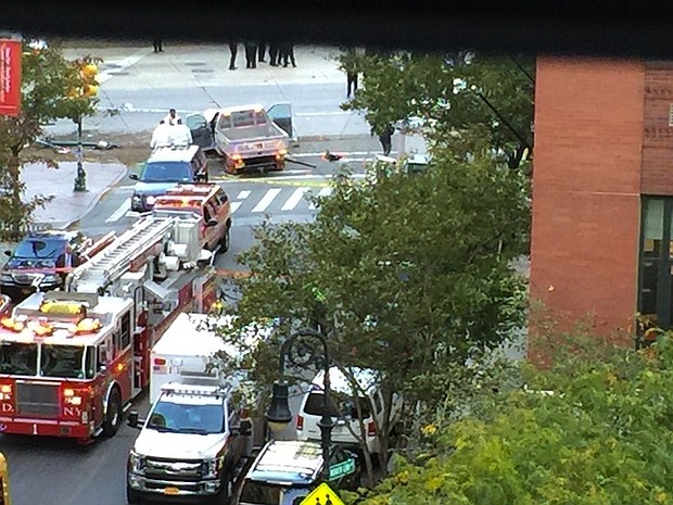 After crashing the truck into a school bus, the suspect exited the vehicle while displaying imitation firearms and was shot in the abdomen by a police officer, according to the NYPD/Source:	Paul Moses