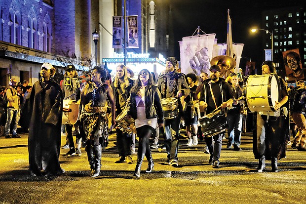 
Costumed revelers head toward Oregon Hill on Tuesday night during the 12th Annual Halloween Parade. All The Saints Theater Company, led by Lilly Lamberta, staged the satirical event. This year’s theme: “Funeral for the Confederacy.” The parade featured puppets representing abolitionists Harriet Tubman and Frederick Douglass and civil rights activist Angela Davis. The parade also included a tribute to Black Lives Matter. The parade drew about 2,000 people and promotes fun while taking a poke at racism and bigotry. 