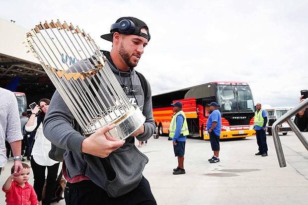 The MVP, George Springer, bringing the Commissioner’s Trophy home to Houston./Houston Astros' Facebook
