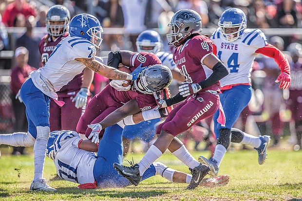 Wild with pride // Fans weren’t let down. The VUU Panthers defeated the Elizabeth City State University Vikings 37-21. Below center, on this play, VUU freshman running back Tabyus Taylor hangs on to the ball as he’s crumpled by the Vikings defense.