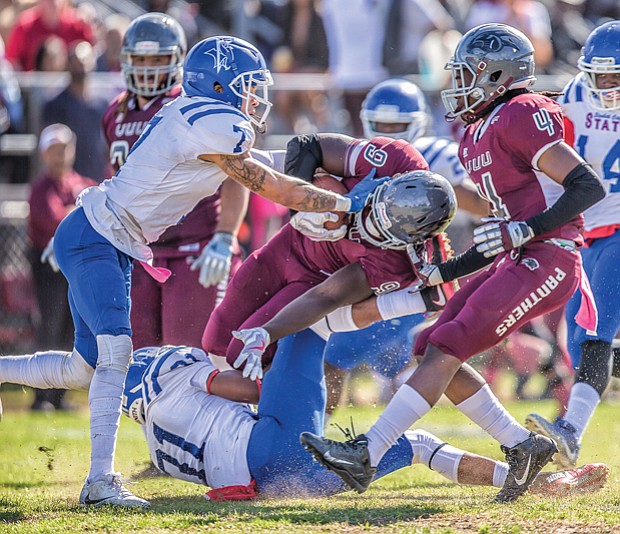 Wild with pride // Fans weren’t let down. The VUU Panthers defeated the Elizabeth City State University Vikings 37-21. Below center, on this play, VUU freshman running back Tabyus Taylor hangs on to the ball as he’s crumpled by the Vikings defense.