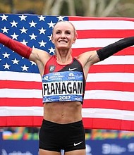   Shalane Flanagan celebrates her historic New York City Marathon victory on Sunday.