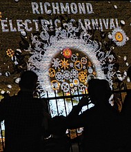 Passersby enjoy “Electric Carnival” by Todd Berreth, Lee Cherry, Patrick Fitzgerald and Emil Polyak, 
