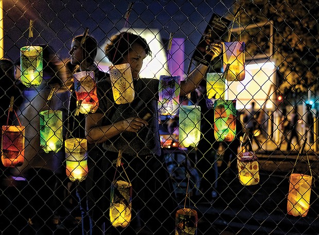 Lanterns decorated by participants hang on a fence before the event’s Lantern Parade. 