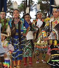 Honoring ancestors and culture // Dancers in traditional dress perform the “Honor Dance,” memorializing members of their Native American tribes during the Great American Indian Expo last Saturday at Richmond Raceway. 
