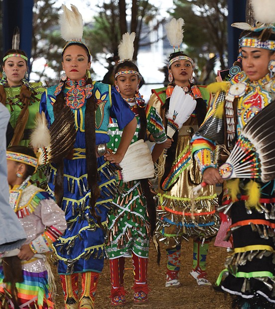 Honoring ancestors and culture // Dancers in traditional dress perform the “Honor Dance,” memorializing members of their Native American tribes during the Great American Indian Expo last Saturday at Richmond Raceway. 
