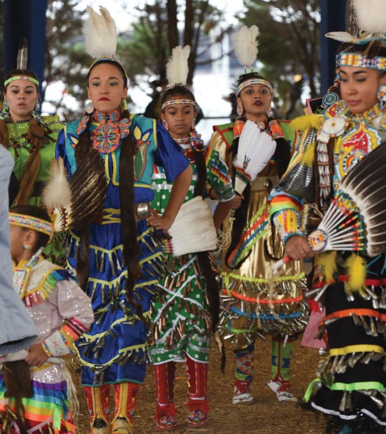 Honoring ancestors and culture // Dancers in traditional dress perform the “Honor Dance,” memorializing members of their Native American tribes during the Great American Indian Expo last Saturday at Richmond Raceway. 
