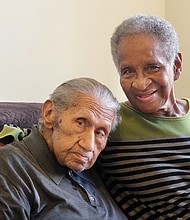 Elizabeth “Bette” Mitchell smiles with her husband, John “Tiger Tom” Mitchell, at their South Side home when he turned 100 in 2016.