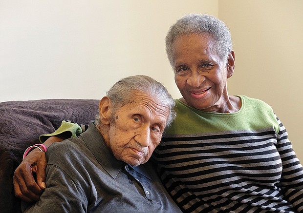 Elizabeth “Bette” Mitchell smiles with her husband, John “Tiger Tom” Mitchell, at their South Side home when he turned 100 in 2016.