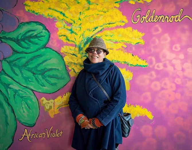 Artist Arlene Turner-Crawford stands in front of the mural she helped to create on the North and South walls of the 64th and Dorchester Streets viaduct during the Nov. 9 dedication ceremony. The mural was a collaborative effort between the artists, commissioners and the Woodlawn community. Photo Credit:Kaye Cooksey