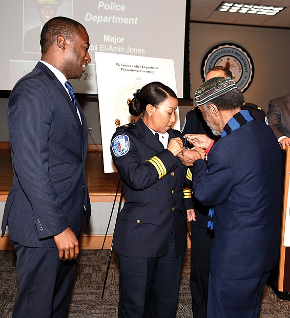 Major accomplishment
Richmond Police Maj. Sybil El-Amin Jones is pinned by her father, Bilal El-Amin, during the city police department’s promotion ceremony Nov. 16 at the training academy. Seventeen officers were promoted during the ceremony, with Maj. El-Amin attaining the highest rank. She is the second African-American female major in the department’s history. 