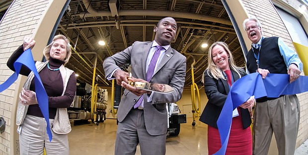 New city Public Utilities center // Mayor Levar M. Stoney cuts the ribbon to open a new $9.4 million center for the city Department of Public Utilities that includes modern labs and offices. Location: 1801 Commerce Road in South Side. At least 90 employees will work at the facility, including 14 technicians who monitor and test the city’s drinking water and wastewater to ensure the city is meeting federal regulations. The building also will house workers involved with stormwater and wastewater management. DPU purchased the building four years ago for $750,000. The department said the new center will improve efficiency by consolidating in one building employees who were scattered at four sites. Celebrating with the mayor are, from left, Rosemary Green, interim director of Public Utilities; Jennifer Hatchett, director of the new facility; and Robert Steidel, the city’s deputy chief administrative officer for operations. 
