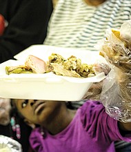 Holiday sharing // People of all ages pitched in to serve others last week at area Thanksgiving celebrations. Top left, Tianna Fields, 5, reaches with a gloved hand to put a roll on a dinner plate for one of the senior residents of the former Essex Village apartment complex in Henrico County. 
