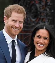 Britain’s Prince Harry poses with his fiancée, U.S. actress Meghan Markle, at the Sunken Garden at Kensington Palace in London following Monday’s formal announcement of their engagement.