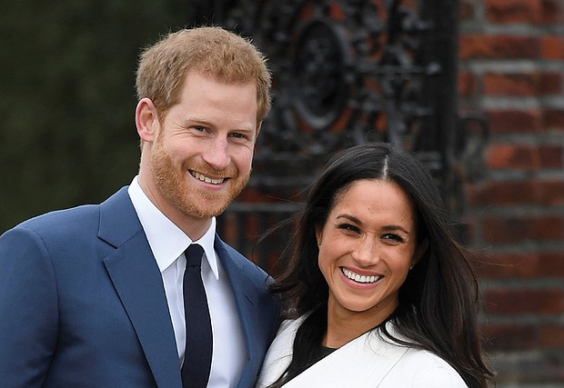 Britain’s Prince Harry poses with his fiancée, U.S. actress Meghan Markle, at the Sunken Garden at Kensington Palace in London following Monday’s formal announcement of their engagement.