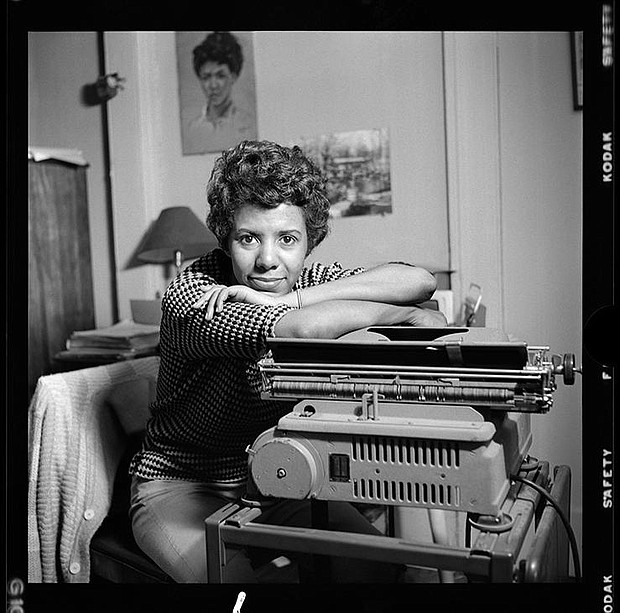 Lorraine Hansberry leans over her typewriter in her Greenwich Village apartment on Bleecker Street during her April 1959 photoshoot for Vogue. Photo by David Attie.