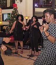 Dancing and singing the night away
Micah White, executive director of the Central Virginia African-American Chamber of Commerce, and Carlette Mitchell dance to J Baxter & The SAUCE Band during the chamber group’s holiday celebration Nov. 29 at The Speakeasy in Jackson Ward. 
