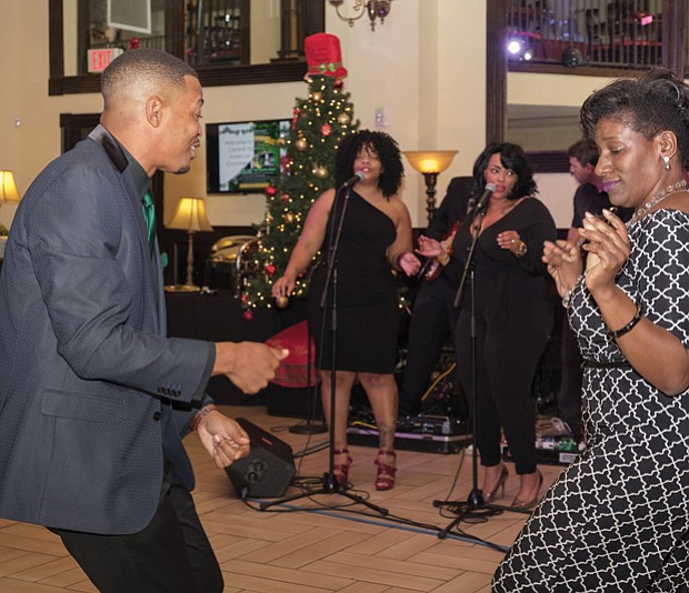 Dancing and singing the night away
Micah White, executive director of the Central Virginia African-American Chamber of Commerce, and Carlette Mitchell dance to J Baxter & The SAUCE Band during the chamber group’s holiday celebration Nov. 29 at The Speakeasy in Jackson Ward. 
