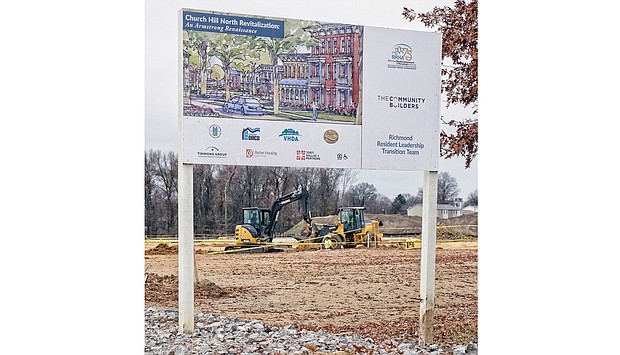 A sign offers the vision of the planned Church Hill North development that now needs a $4.9 million bailout from City Council. Heavy machinery prepares the land in the 1600 block of North 31st Street for the proposed construction of new apartments and homes on the site of the old Armstrong High School.