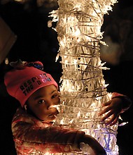 Holiday lights at night // Richmond’s Downtown skyline is bathed in holiday lights as the 33rd Annual Grand Illumination kicked off the season last Friday at the James Center. Children and adults alike were dazzled by the spectacle, including Victoria Austin, 3, who posed with a reindeer as her mother, Samantha, snapped photos. 