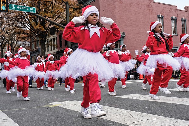 Holiday team spirit //
Youngsters in the Henrico Police Athletic League show their holiday spirit with choreographed moves as they make their way along Broad Street in the Dominion Energy Christmas Parade last Saturday in Downtown. Please see more photo on B3.