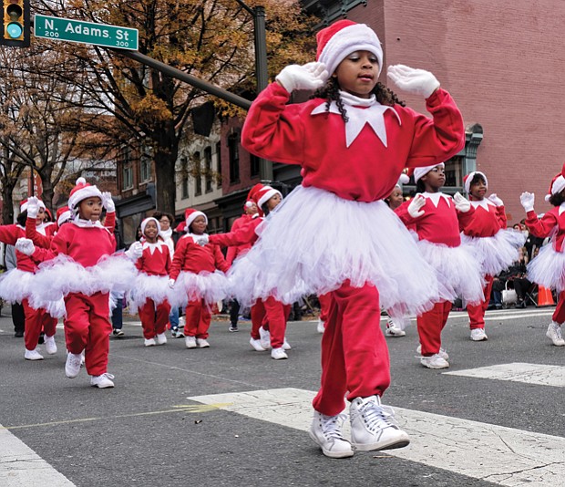 Holiday team spirit //
Youngsters in the Henrico Police Athletic League show their holiday spirit with choreographed moves as they make their way along Broad Street in the Dominion Energy Christmas Parade last Saturday in Downtown. Please see more photo on B3.