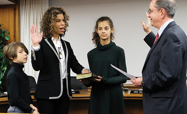 New School Board member
Kenya J. Gibson takes the oath of office Monday for the 3rd District seat on the Richmond School Board from Richmond Circuit Court Clerk Edward F. Jewett, with her daughter, Scarlett, 11, and her son, Phoenix, 8, at her side. Ms. Gibson, a 43-year-old who works in health care marketing, won a four-way contest on Nov. 7 to fill the unexpired term of Jeff Bourne, who was elected to the House of Delegates in February. Ms. Gibson called during the campaign for more funding for public education and additional support for high-risk and underprivileged students. She will serve until 2020. 