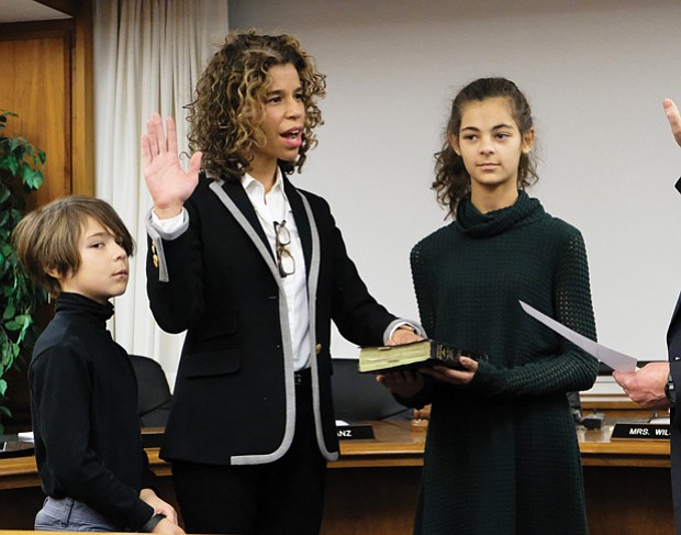 New School Board member
Kenya J. Gibson takes the oath of office Monday for the 3rd District seat on the Richmond School Board from Richmond Circuit Court Clerk Edward F. Jewett, with her daughter, Scarlett, 11, and her son, Phoenix, 8, at her side. Ms. Gibson, a 43-year-old who works in health care marketing, won a four-way contest on Nov. 7 to fill the unexpired term of Jeff Bourne, who was elected to the House of Delegates in February. Ms. Gibson called during the campaign for more funding for public education and additional support for high-risk and underprivileged students. She will serve until 2020. 