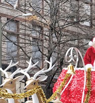 A Toddler catches the attention of the Legendary Santa and the Snow Princess as they travel via reindeer sleigh down Broad Street.