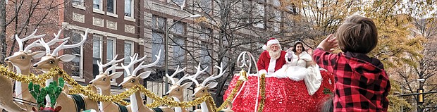 A Toddler catches the attention of the Legendary Santa and the Snow Princess as they travel via reindeer sleigh down Broad Street.