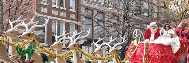 A Toddler catches the attention of the Legendary Santa and the Snow Princess as they travel via reindeer sleigh down Broad Street.