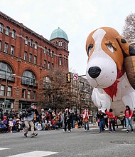 Welcoming Christmas on parade // There’s nothing like a parade to get into the holiday spirit. Thousands of people lined Broad Street from the Science Museum to 7th Street in Downtown for the 34th Annual Dominion Energy Christmas Parade last Saturday. Floats included big inflatables, such as this giant puppy balloon, right, that was guided down the street by a bevy of volunteers. The day wasn’t just for the young. Middle left, adults and seniors cheered and dance on the sidelines as marching bands and cheerleading units pass by. Middle right, grand marshals of this year’s parade, retired NASA mathematician and aeronautical engineer Christine Darden, 
 