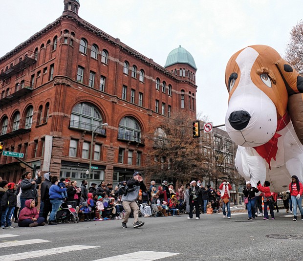 Welcoming Christmas on parade // There’s nothing like a parade to get into the holiday spirit. Thousands of people lined Broad Street from the Science Museum to 7th Street in Downtown for the 34th Annual Dominion Energy Christmas Parade last Saturday. Floats included big inflatables, such as this giant puppy balloon, right, that was guided down the street by a bevy of volunteers. The day wasn’t just for the young. Middle left, adults and seniors cheered and dance on the sidelines as marching bands and cheerleading units pass by. Middle right, grand marshals of this year’s parade, retired NASA mathematician and aeronautical engineer Christine Darden, 
 