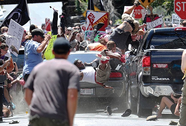 People fly into the air after being struck by a car that plowed into a crowd of counterprotesters at he Aug. 12 valley in Charlottesville. One person was killed and 19 others were injured. The driver, James A. Fields Jr., was charged with second degree murder.