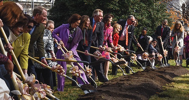 Gov. Terry McAuliffe, center, and his wife, First Lady Dorothy McAuliffe, to his right, are flanked by former Virginia first ladies Lynda Bird Johnson Robb (in purple) and Susan Allen (in pink) as they break ground Monday for the monument in Capitol Square that will honor women’s roles in Virginia’s history for more than 400 years. 