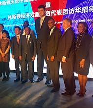 Above, Mayor Turner signs an economic memorandum with Beijing Mayor Chen Jining, making progress toward more trade that could bring more jobs and investments to Houston. Below, Yao Ming joins members of the Houston trade delegation at an Air China reception; several delegation members gather.
