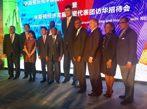 Above, Mayor Turner signs an economic memorandum with Beijing Mayor Chen Jining, making progress toward more trade that could bring more jobs and investments to Houston. Below, Yao Ming joins members of the Houston trade delegation at an Air China reception; several delegation members gather.
