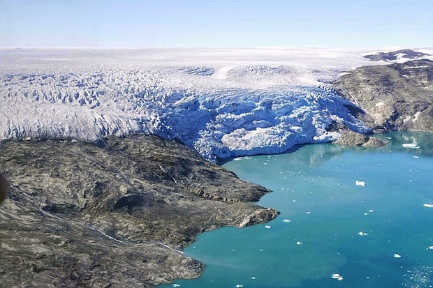 Ice flows from Helheim Glacier into Sermilik Fjord, in eastern Greenland.