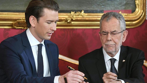 Austrian President Alexander Van der Bellen (R) and Austrian Chancellor of the conservative People's Party (OeVP) Sebastian Kurz sign the letter of appointment during the inauguration ceremony.