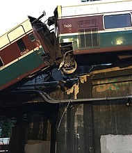An Amtrak train car derailed and is dangling on to Interstate 5 in Pierce County, Washington, according to the Washington State Department of Transportation's twitter. All southbound lanes of the I-5 are closed due to the derailment.