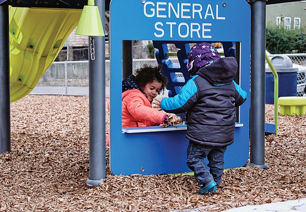 Amanda Gamble, 2, pretends to sell leaves to her year-old brother, 