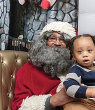 Christmas wishes // 
Quintus Ferguson IV, 18 months, gazes with wide-eyed wonder as he poses with Soul Santa at the Black History Museum and Cultural Center of Virginia. The museum in Jackson Ward has sponsored the legendary Soul Santa’s trips from the North Pole for more than a decade.