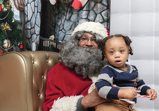 Christmas wishes // 
Quintus Ferguson IV, 18 months, gazes with wide-eyed wonder as he poses with Soul Santa at the Black History Museum and Cultural Center of Virginia. The museum in Jackson Ward has sponsored the legendary Soul Santa’s trips from the North Pole for more than a decade.