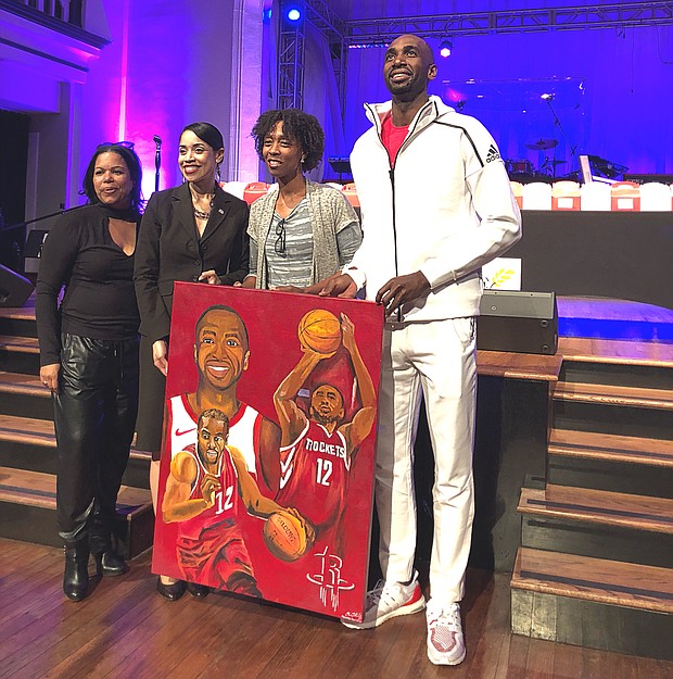 Mbah A Moute being presented with a gift from the Bread of Life Organization
from left to right:
Katherine Flowers
Council Woman Amanda Edwards
Artist Charis Kelly
Houston Rockets Forward Luc Mbah A Moute