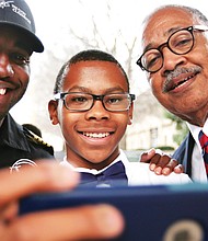 Student Nick Booker, center, takes a selfie with aviator Barrington Irving, left, and Douglass School Dean Elbert Brinson after Mr. Irving’s February talk at the Science Museum of Virginia.