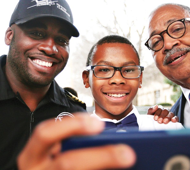 Student Nick Booker, center, takes a selfie with aviator Barrington Irving, left, and Douglass School Dean Elbert Brinson after Mr. Irving’s February talk at the Science Museum of Virginia.