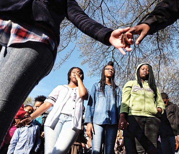 Teens mourn the shooting deaths of friends Mikkaisha D. Smoot, 16 and Taliek K. Brown, 15, during a prayer vigil in April in Mosby Court. Below, Julius Jackson, left, and Tristan Albers of Chimborazo Elementary School perform the tango at the Dancing Classrooms GRVA Colors of the Rainbow Team Match in April.