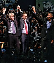 Former President Barack Obama energizes the crowd during a campaign appearance in Richmond with Virginia’s Democratic ticket candidates, from left, Justin Fairfax, lieutenant governor; Mark Herring, attorney general; and Ralph S. Northam, governor. Right, Virginia State University tailback Trenton “Boom” Cannon goes airborne for a touchdown in the Trojans’ nail-biting 40-39 victory over Virginia Union University on Nov. 4.