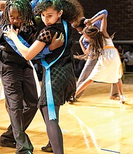 Julius Jackson, left, and Tristan Albers of Chimborazo Elementary School perform the tango at the Dancing Classrooms GRVA Colors of the Rainbow Team Match in April.